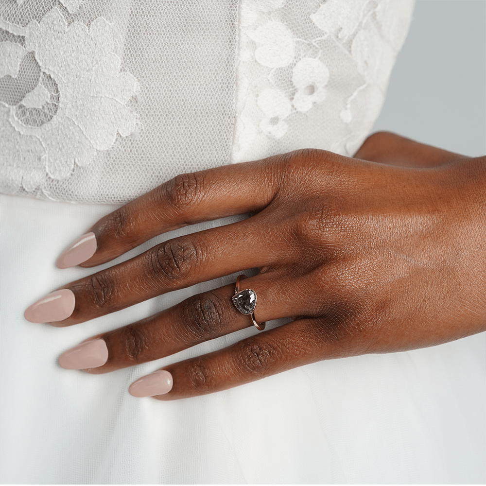Woman wearing a Solid Gold engagement ring with a salt and pepper stone - Women's Wedding Rings - Manly Bands
