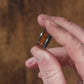 Trying on a Black Zirconium (charcoal gray color) with Desert Ironwood Men's Wedding Rings - Manly Bands
