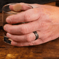 Man wearing a Black Zirconium (charcoal gray color) with Black Diamonds Wedding Ring while having a drink - Manly Bands